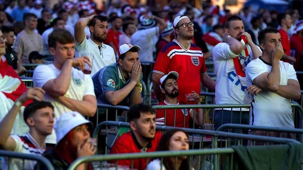 England fans are dejected after Italy's Leonardo Bonucci scores the equalising goal to level the score at 1-1 at the fan zone in Trafford Park, Manchester as they watch the UEFA Euro 2020 Final between Italy and England. Picture date: Sunday July 11, 2021.