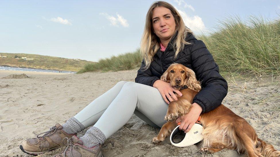 Louise Kinsey sitting on a beach