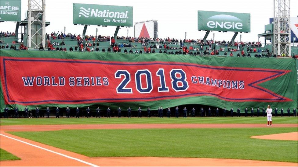 A 2018 World Series Champions banner is unrolled before a game between the Boston Red Sox and the Toronto Blue Jays during pregame ceremonies at Fenway Park.