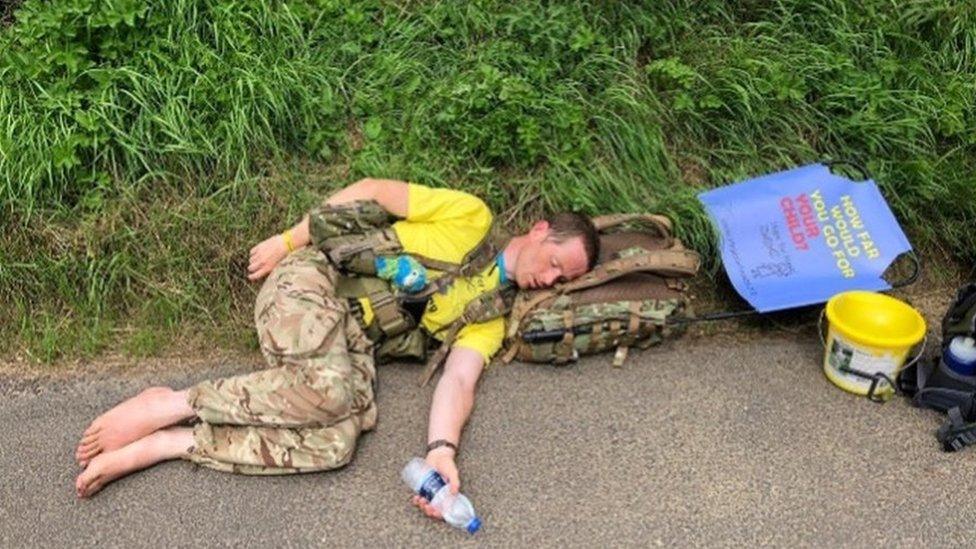 Major Chris Brannigan asleep on the side of the road during his 700 mile barefoot walk last year