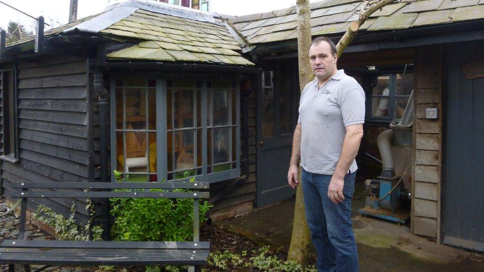 Richard Frost beside one of his four sheds