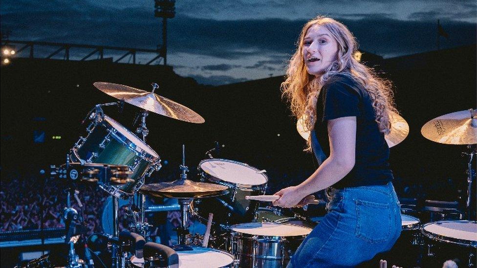 Schoolgirl Grace Ellis drums at The Killers concert at Carrow Road