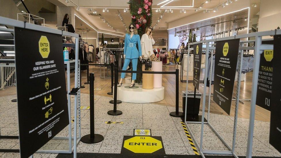 Signage reminding shoppers of social distancing rules in a River Island store in Liverpool, as shops make preparations to reopen following the introduction of measures to bring England out of lockdown.