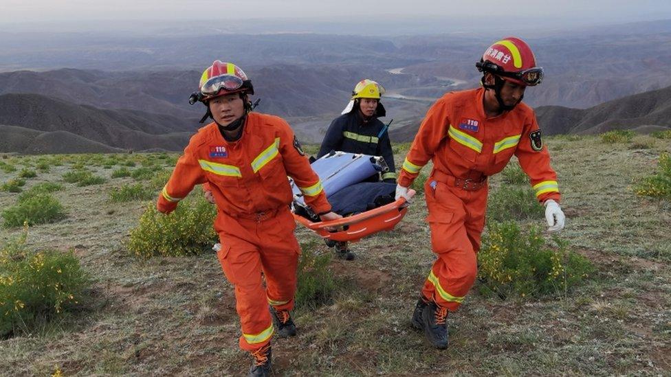 Rescue workers carry a stretcher as they work at the site where extreme cold weather killed participants of an 100-km ultramarathon race in Baiyin, Gansu province.