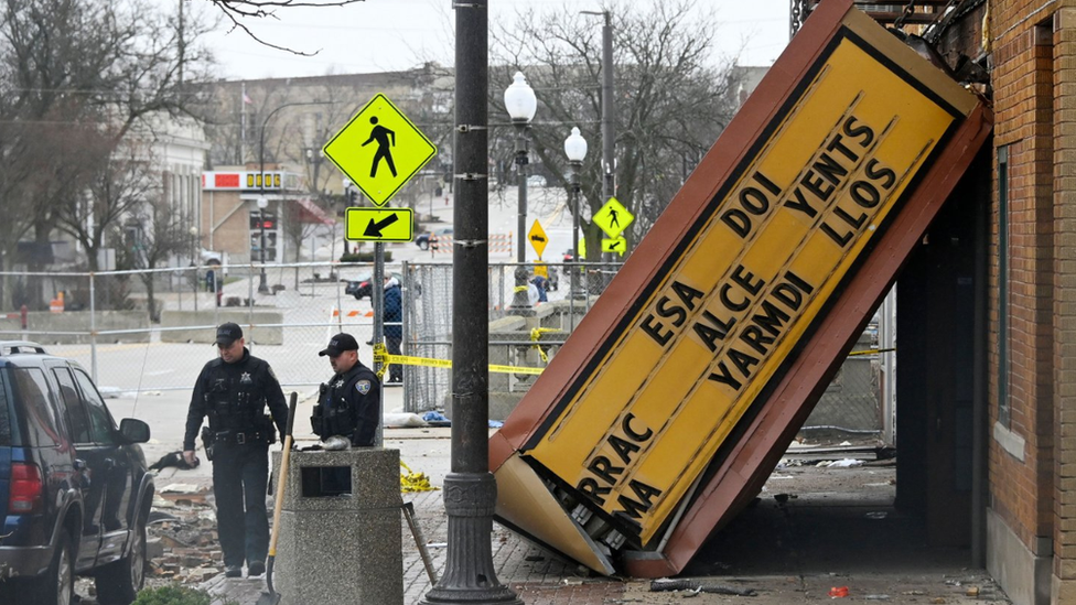 nvestigators look over the Apollo Theater following a tornado in Belvidere, Illinois