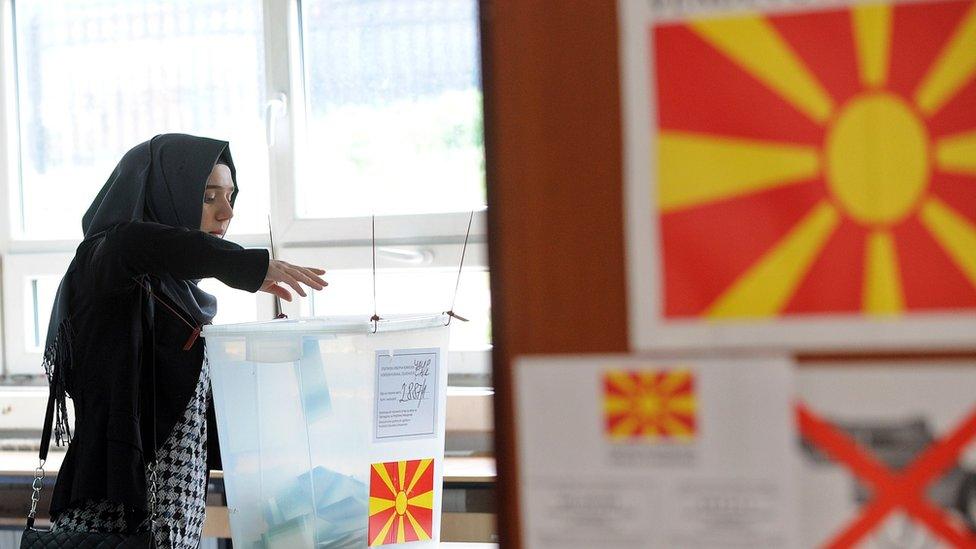 A woman casts her ballot in a Macedonian election