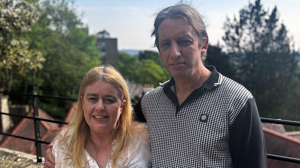 Sharon is pictured with her partner Martin