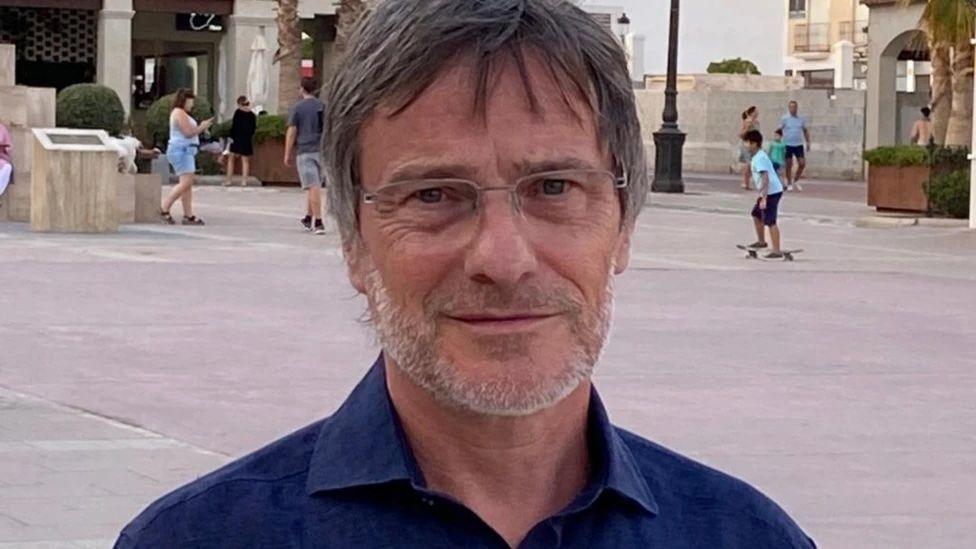 Recently retired special school head teacher Martin Hanbury, wearing an open-necked dark blue shirt, poses for a photograph.