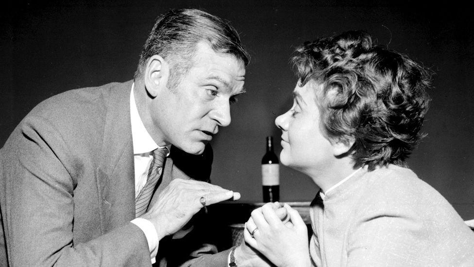 Black and white photo of Laurence Olivier and Joan Plowright facing each other in rehearsals for The Entertainer