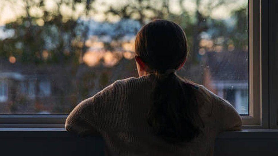 child looking out a window - generic