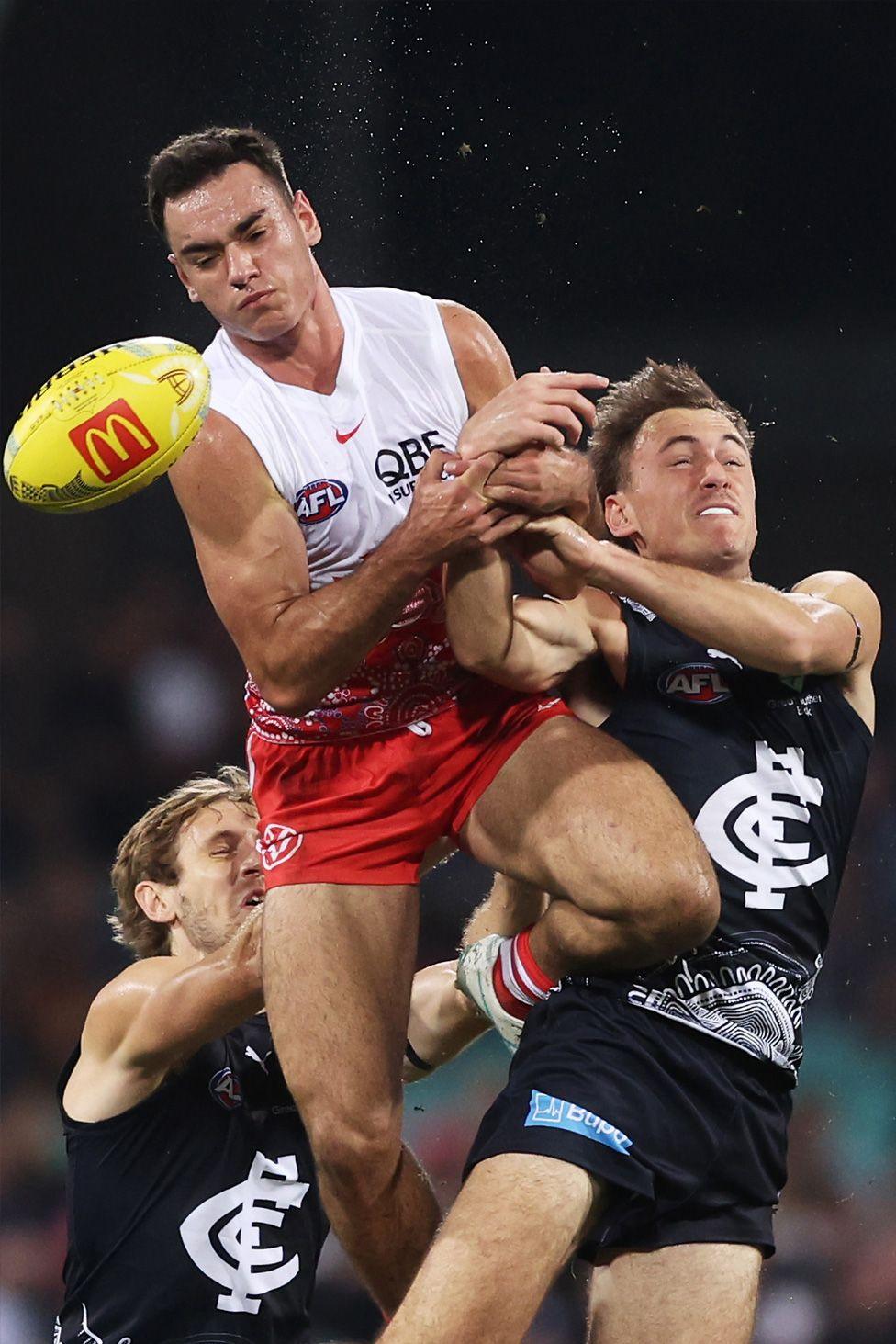 Caiden Cleary of the Sydney Swans leaps to compete for a high ball against Carlton's Matthew Carroll. Photo by Matt King