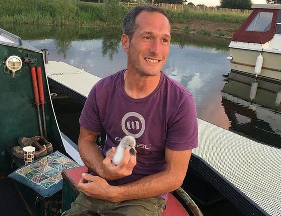 Rob Adamson with a cygnet