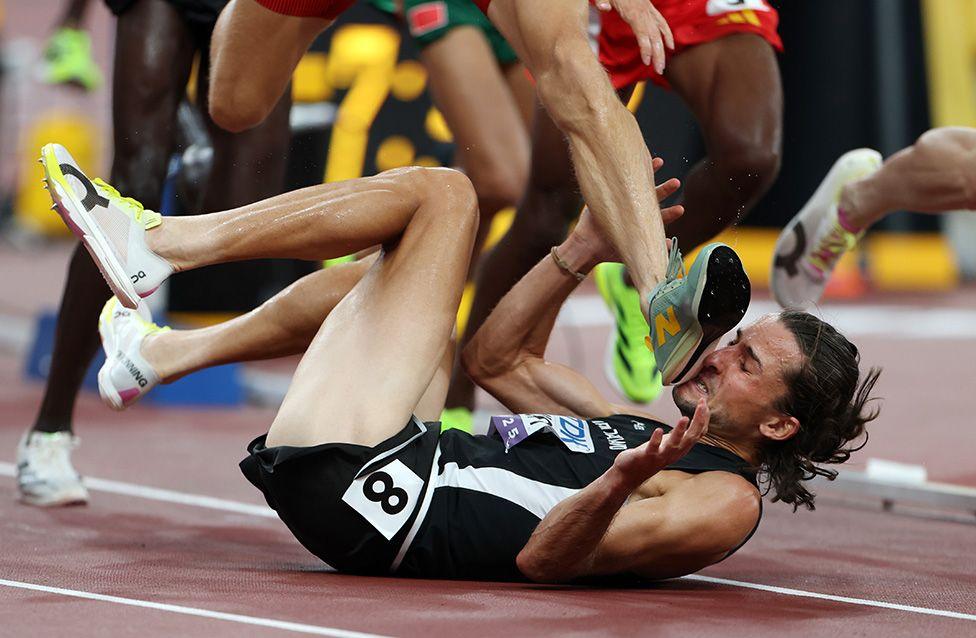 New Zealand's Geordie Beamish is stepped on by a competitor after falling in the men's 3,000m steeplechase heats at the World Athletics Championships. Photo by Emilee Chinn