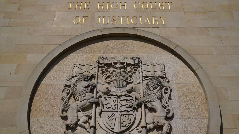 The High Court in Glasgow, a carved sign outside with the words The High Court of Justiciary.