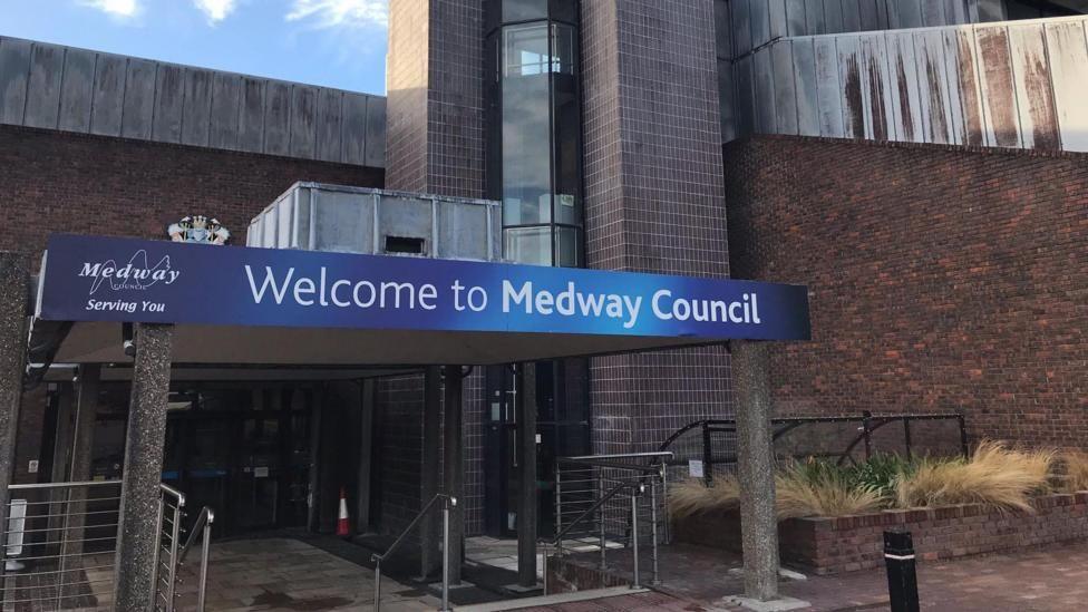 A building with a gantry over the front entrance. The gantry has a blue sign reading "Welcome to Medway Council" on it.