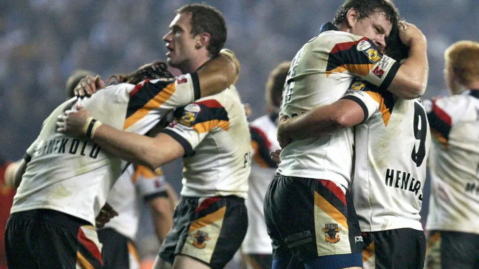 Bradford players Jamie Peacock and Lesley Vainikolo embrace at Old Trafford in the Grand Final against Leeds with a hug. Lee Radford and Ian Henderson also come together in jubilation as the Bulls edge closer to winning the title.