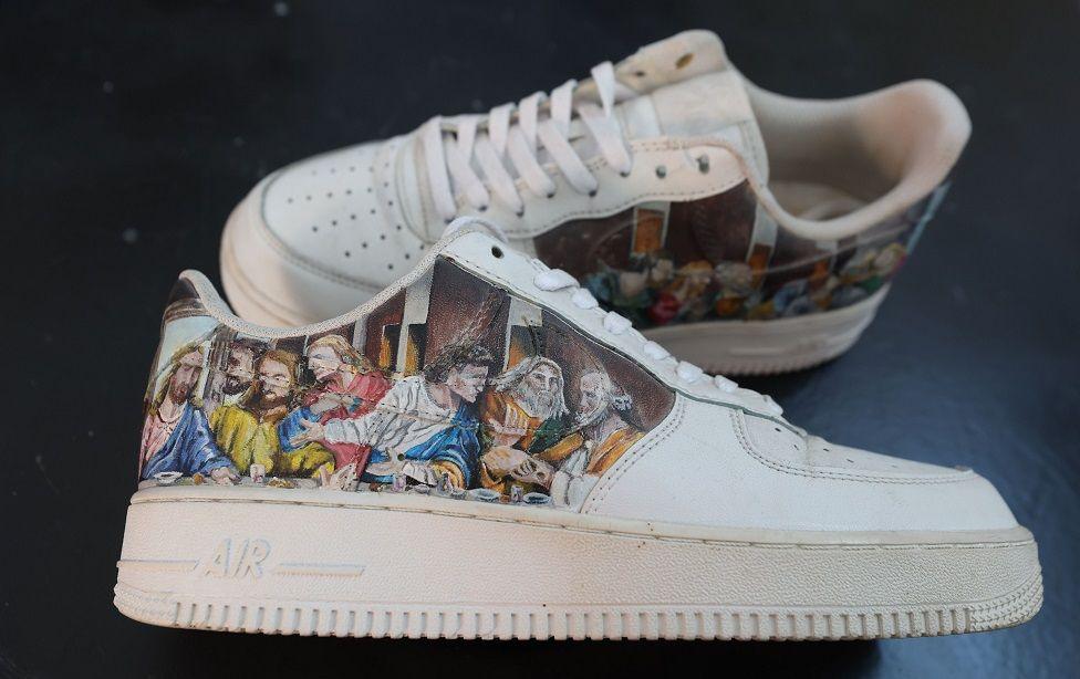 A pair of Nike trainers are seen with a depiction of the Last Supper.