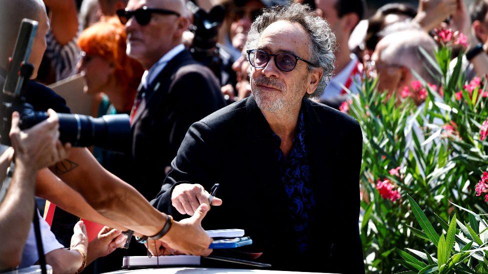 Director Tim Burton signs autographs, on the day of a photocall for the film "Beetlejuice Beetlejuice", which is screening out of competition, at the 81st Venice Film Festival, Venice, Italy, August 28, 2024