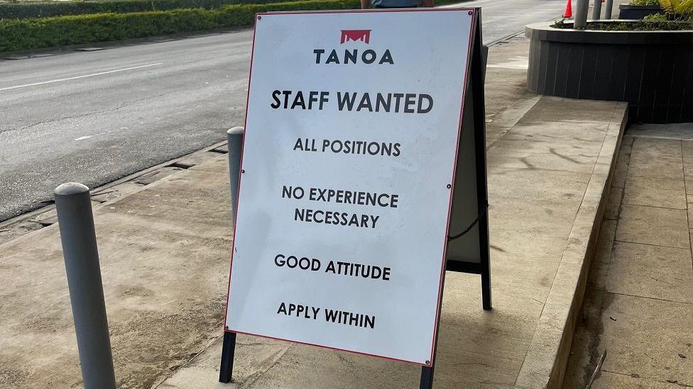 Sign for a hotel reading “All positions, no experience necessary, good attitude, apply within” 