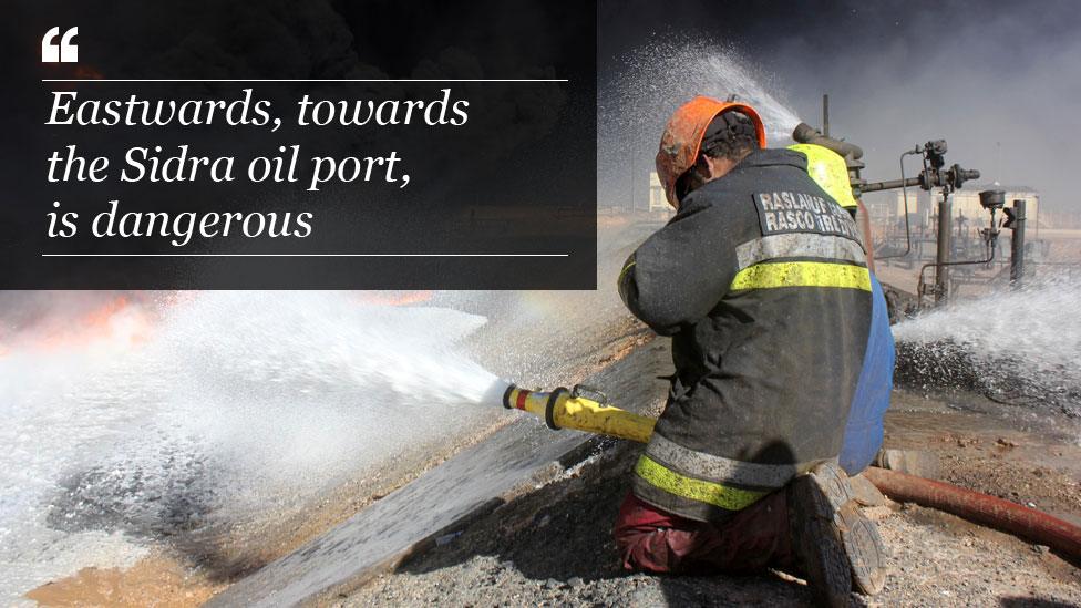 Firefighter at oil depot near Ras Lanuf