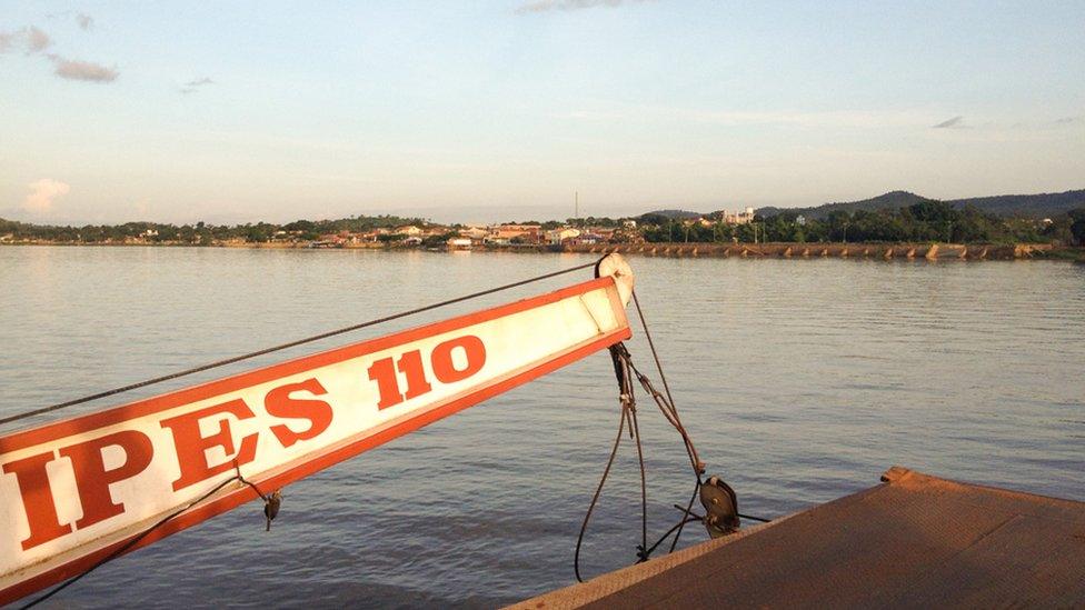 A ferry over the Rio Araguaia, with the village of Xambioa in the distance