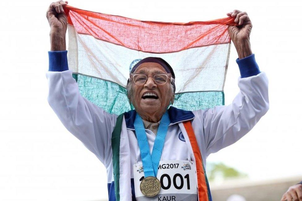 101-year-old Man Kaur from India celebrates after competing in the 100m sprint in the 100+ age category at the World Masters Games at Trusts Arena in Auckland on April 24, 2017.