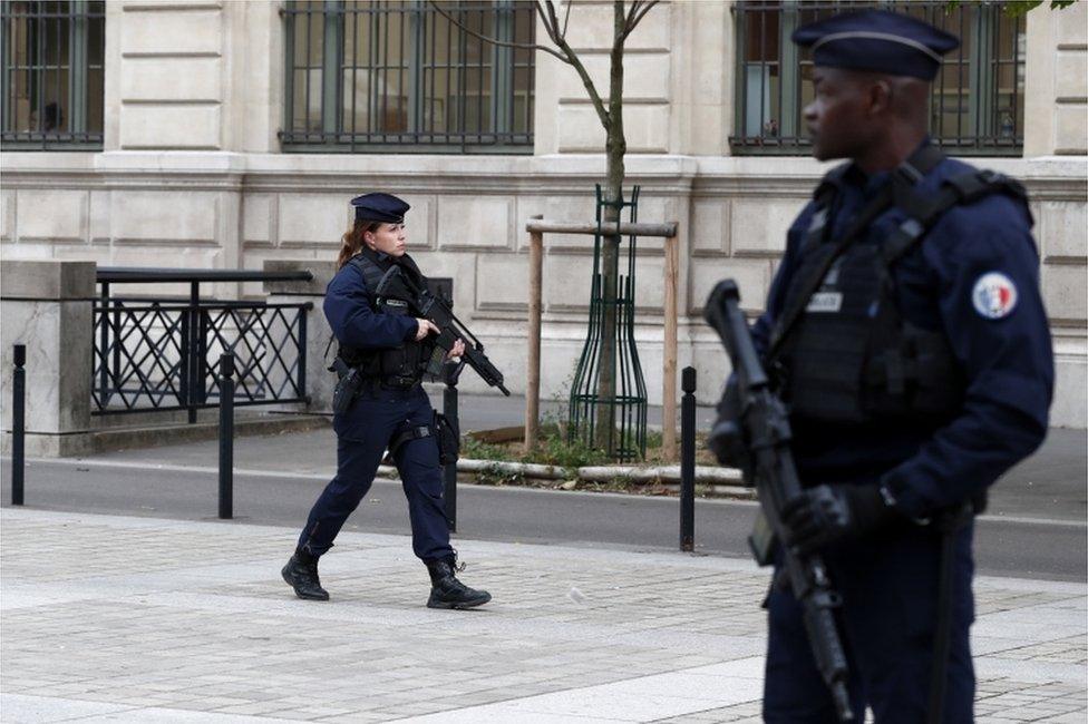 French police and security forces establish a security perimeter near Paris police headquarters.