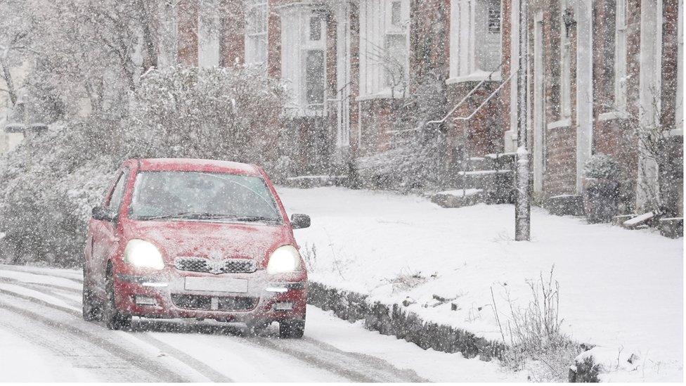 A car driving through a snow flurry in Lenham, Kent