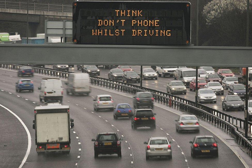 A motorway sign warns drivers not to use their mobile phones