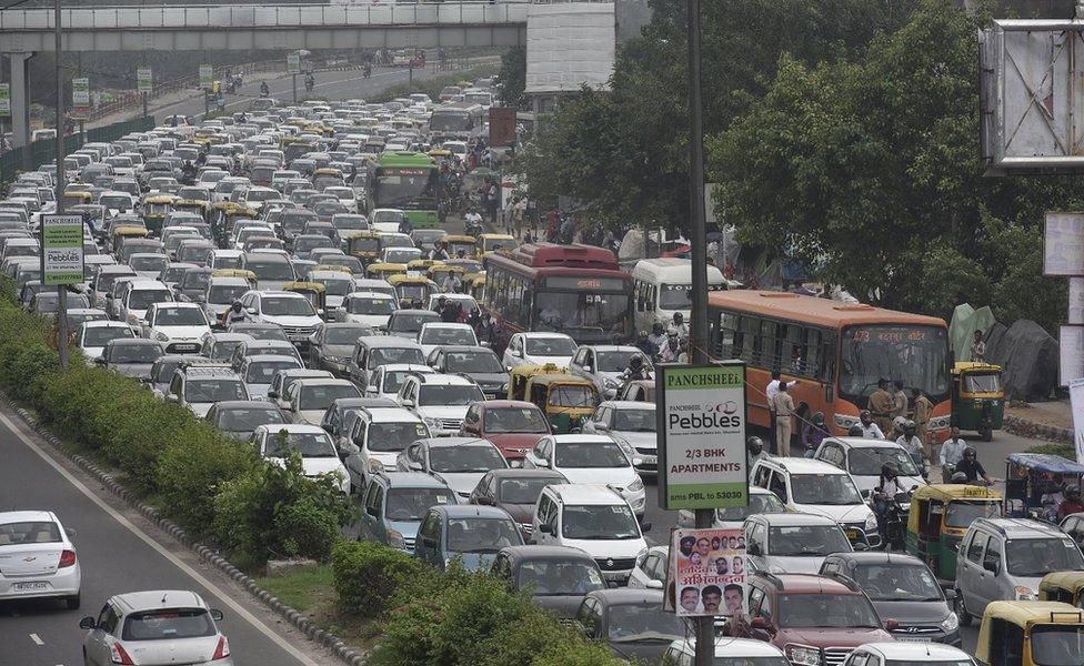 Travellers face traffic congestion on NH-24 as Kanwadias (Dak Kawad) carry holy water for Lord Shiva collected form the River Ganga, on August 1, 2016 in New Delhi, India. (P