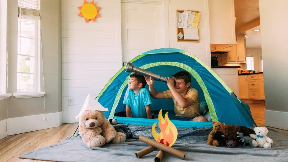 children in tent inside house