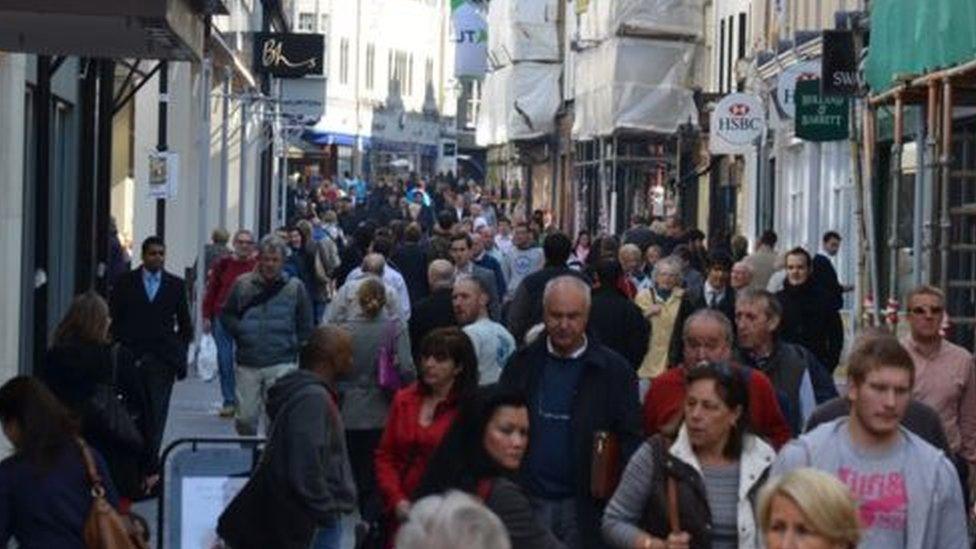 People walking along St Helier high street, Jersey