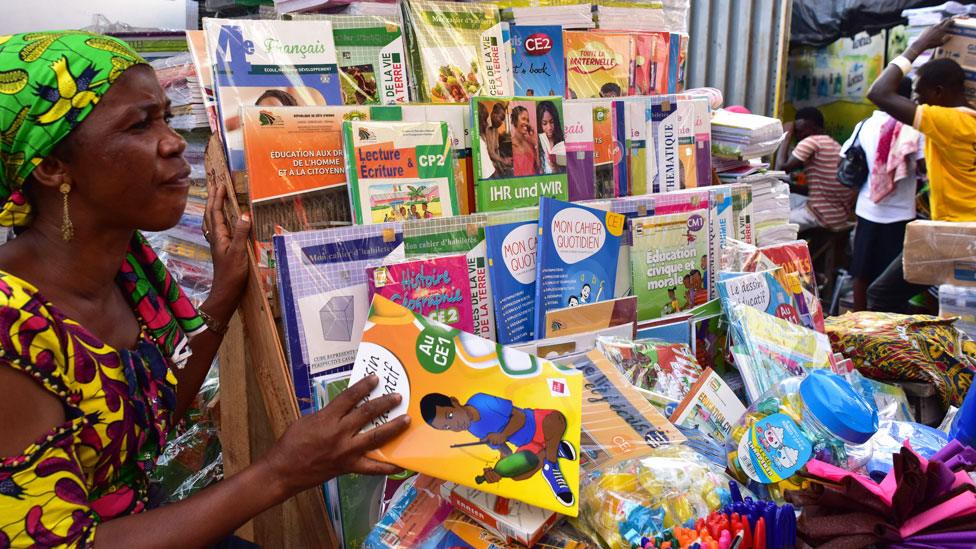 A woman selling French second-hand books in Abidjan, Ivory Coast