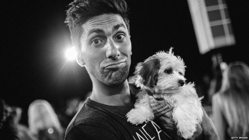 Nev with a rescue puppy on the red carpet at last year's MTV Awards