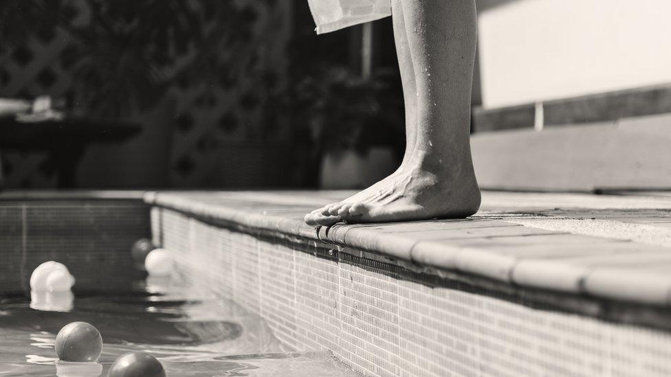 Feet by a swimming pool