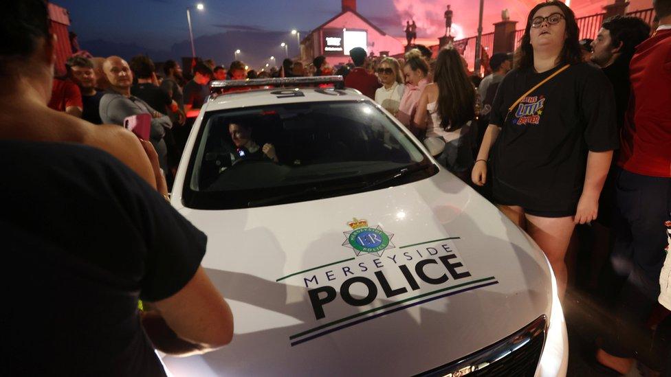 Police car in crowd outside Anfield