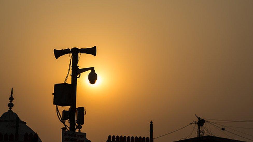 View Of Sun Behind Cctv Pole In Old Delhi, Delhi, India - stock photo