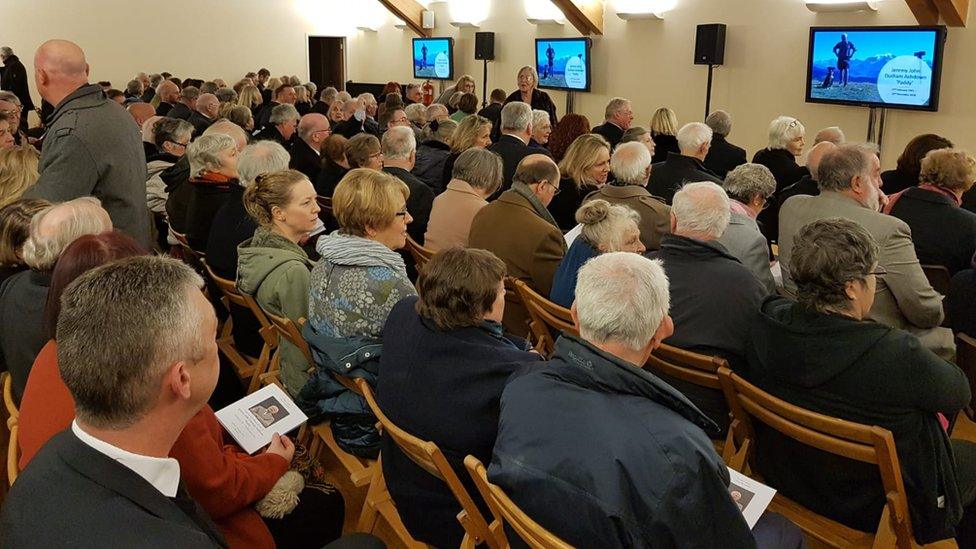 Mourners attending the funeral