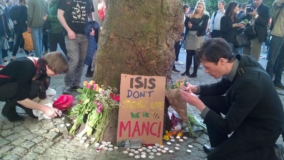 Candles and tributes were left as thousands attended a vigil in Albert Square