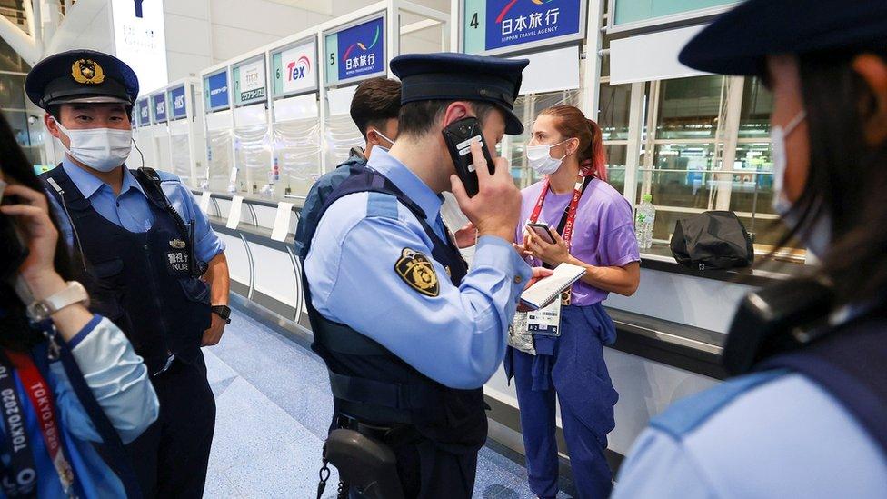 Krystsina Tsimanouskaya surrounded by police