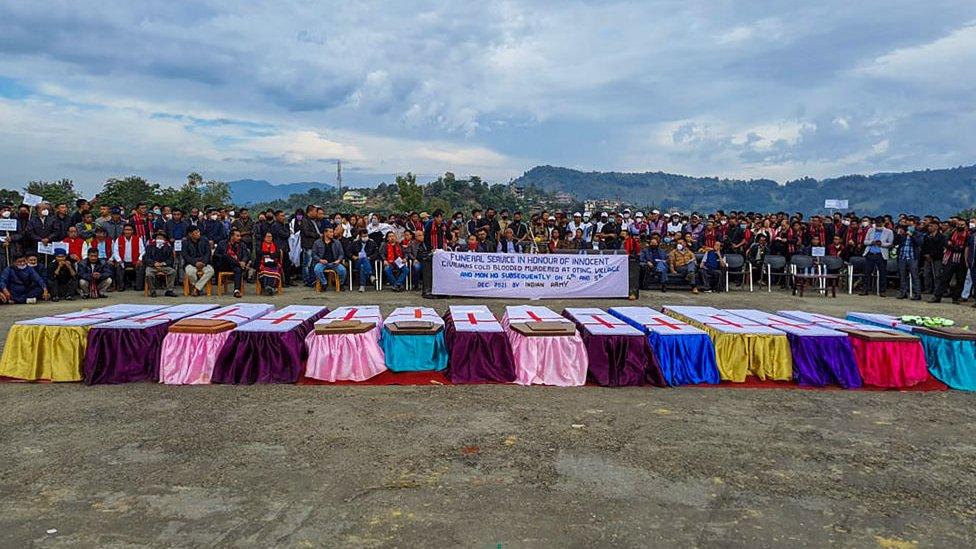 People attend a mass funeral of 14 civilians killed by Indian security forces in Mon district, Nagaland, on December 6, 2021.