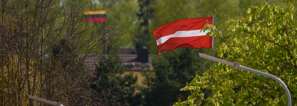 Border between Latvia and Lithuania showing the flags of the two countries