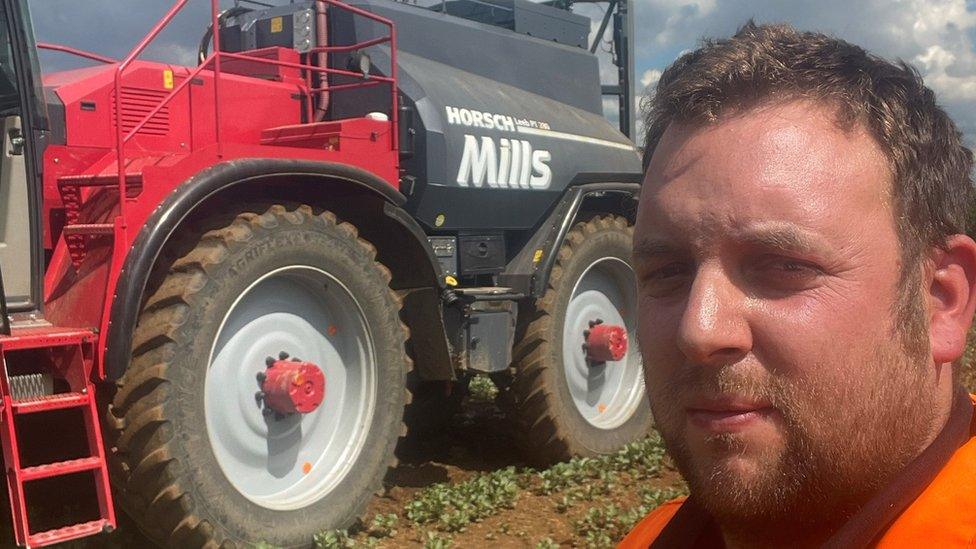 Man in front of tractor