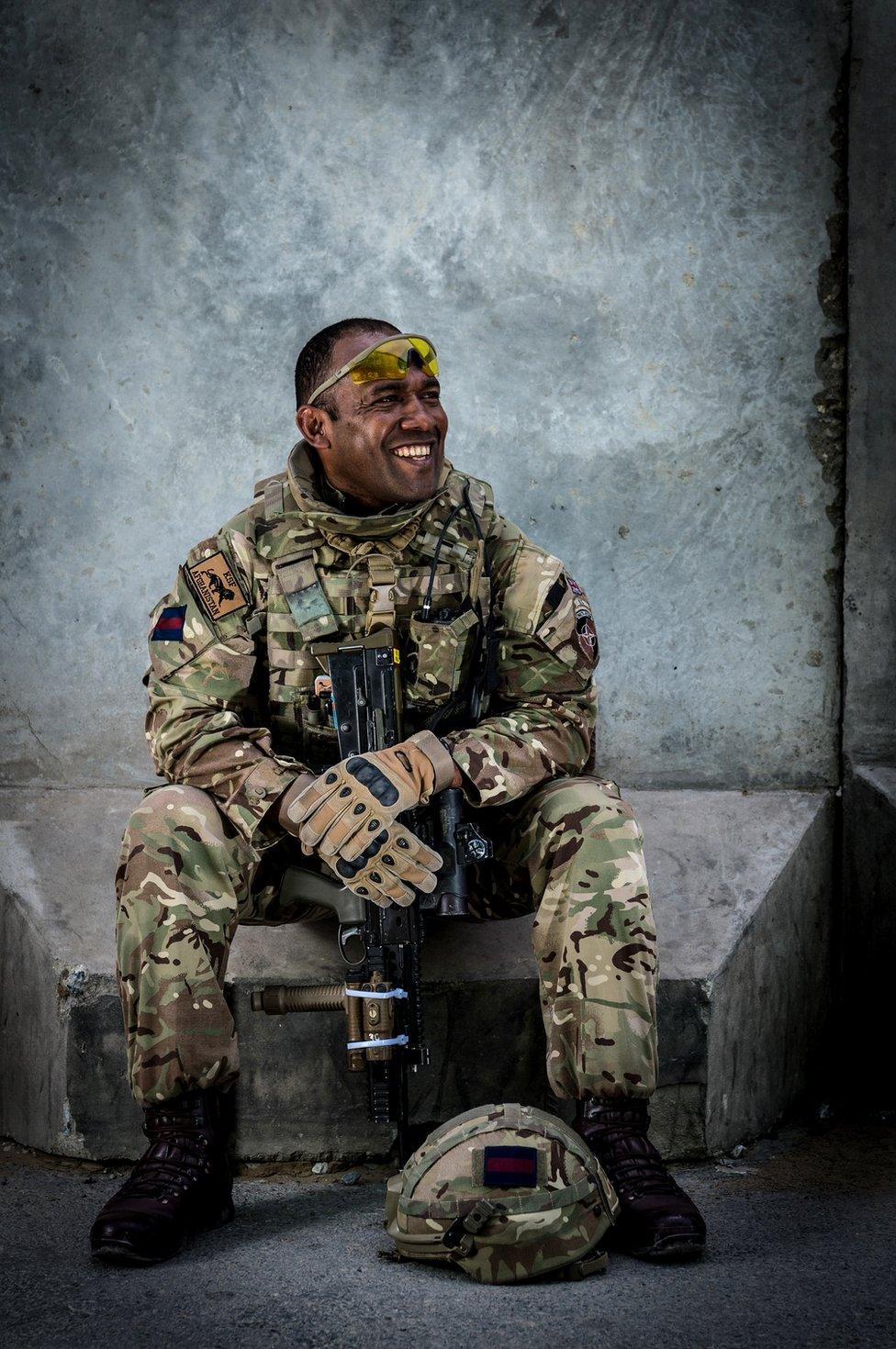 A soldier sat smiling