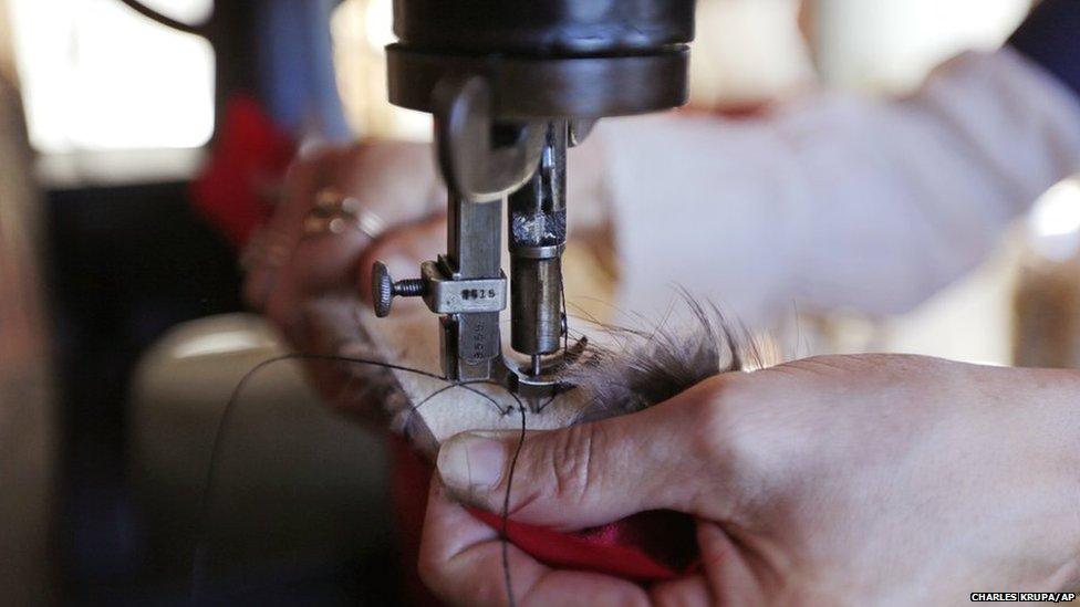 Sewing machine needle going through fur