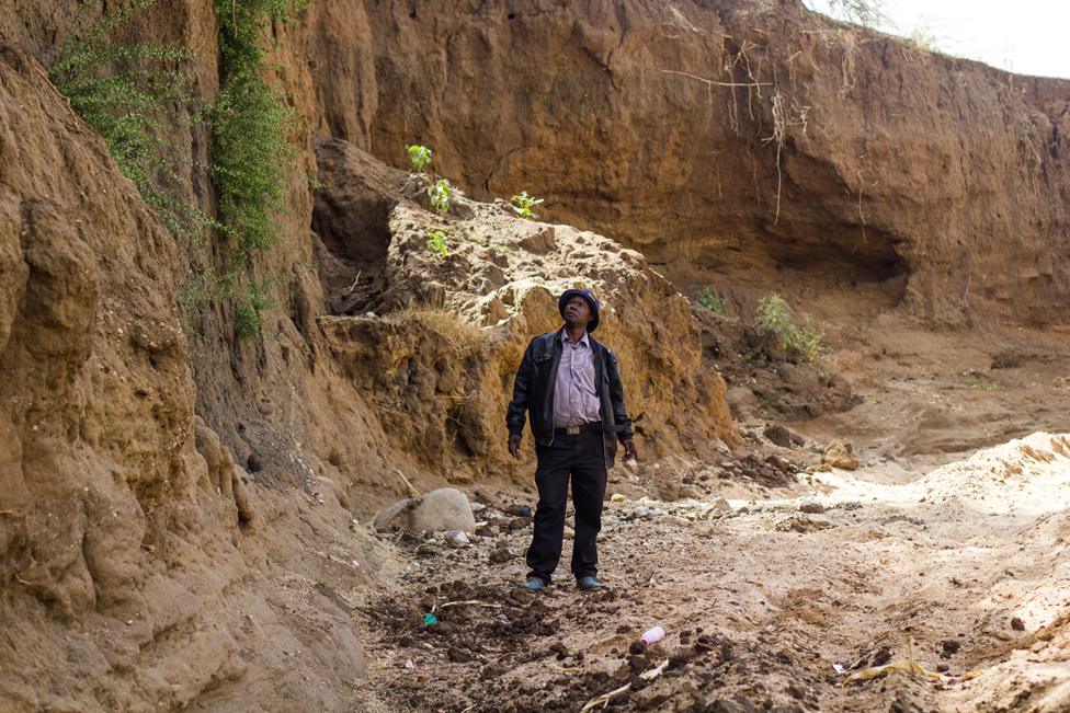 Anthony Mua Kimeu stares at the steep cliffs of the Kilome Ikolya "dead" River