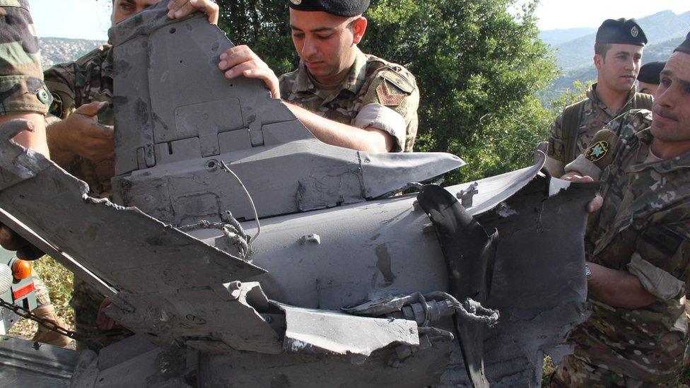 Lebanese soldiers inspect remains of a surface to air missile that landed in the southern Lebanese village of Hebarieh, early on May 10, 2018.