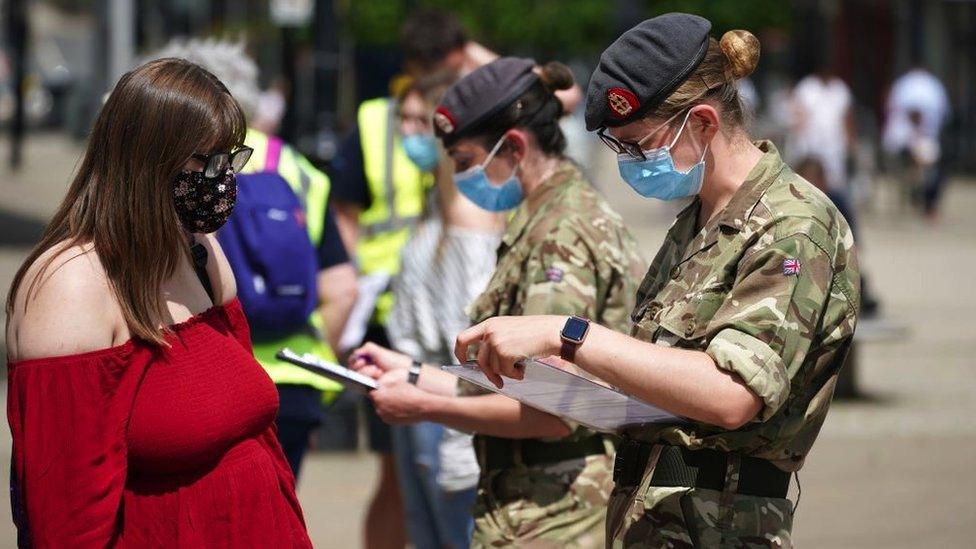 Combat medics from Queen Alexandra's Royal Army Nursing Corps vaccinate members of the public at a rapid vaccination centre