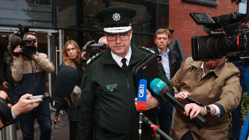 Simon Byrne walks past journalists, TV cameras and microphones days before his resignation as PSNI chief constable