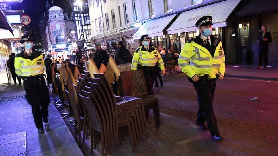 Police patrol through Soho as bars prepare to close in London